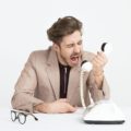 Men yelling no at work into the phone