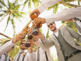 Group of friends celebrating with beer
